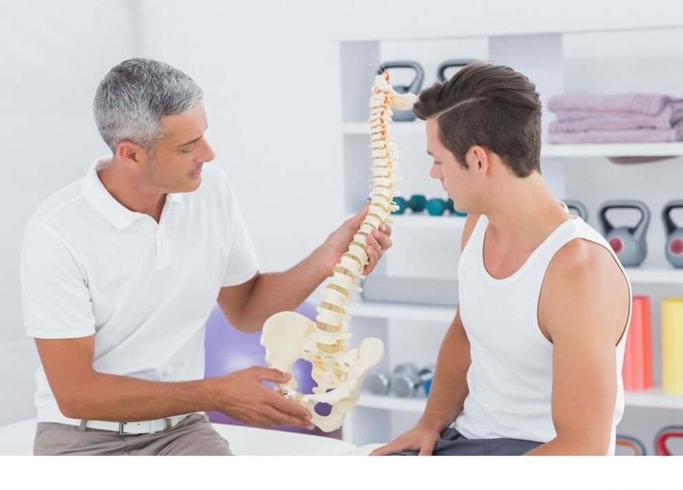 The doctor shows the patient osteoarthritis of the spine
